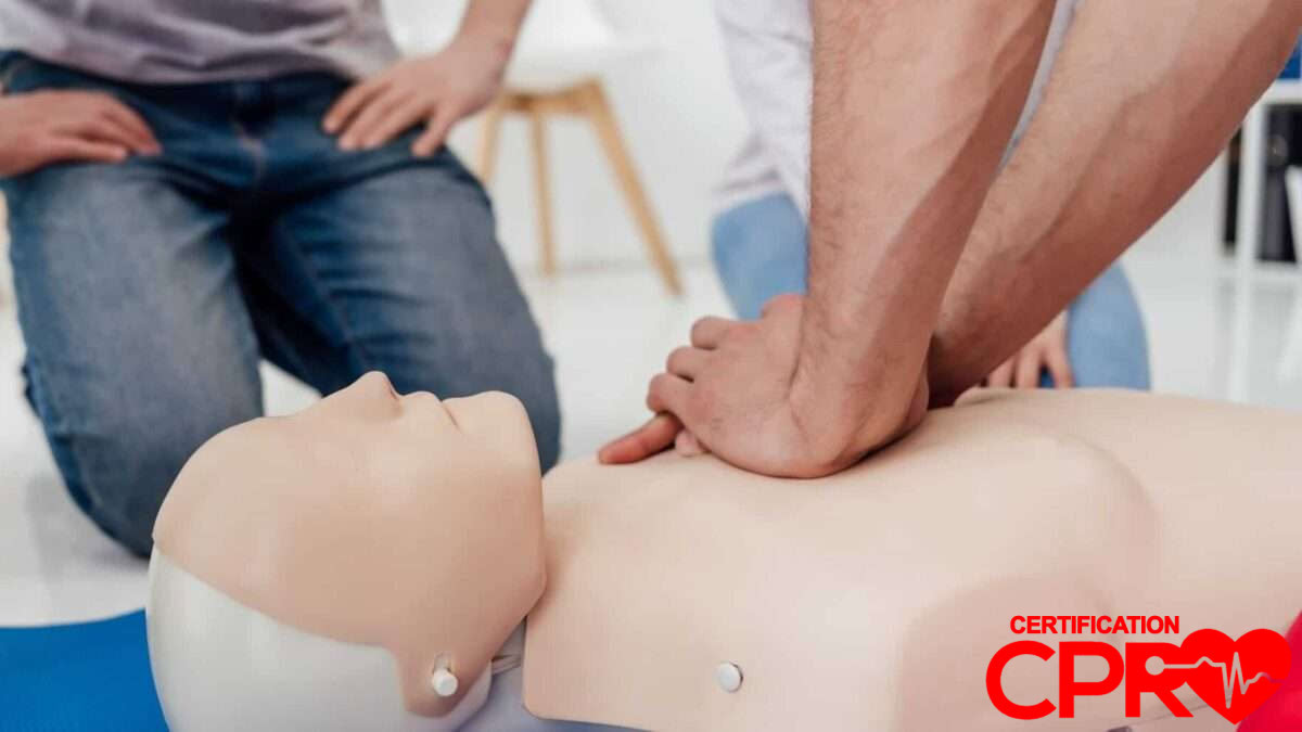 CPR training session with a man practicing on a mannequin in Chicago.
